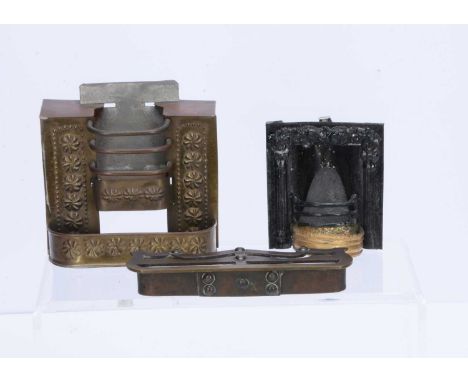 Two early dolls’ house fireplaces, an Evans &amp; Cartwright tinplate fireplace embossed with flowers —3 ½in. (9cm.) high (ba