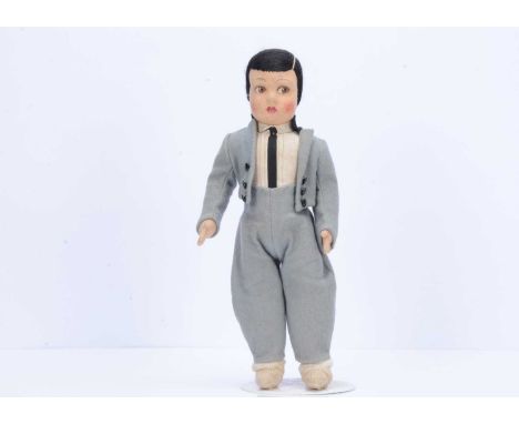 A continental felt boy doll,  similar to Lenci with pressed felt head with brown painted side glancing eyes, black embroidere