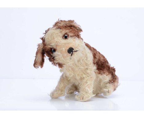 A  Steiff seated Molly dog, circa 1927, with white and  brown tipped mohair, large brown and black glass eyes, black stitched