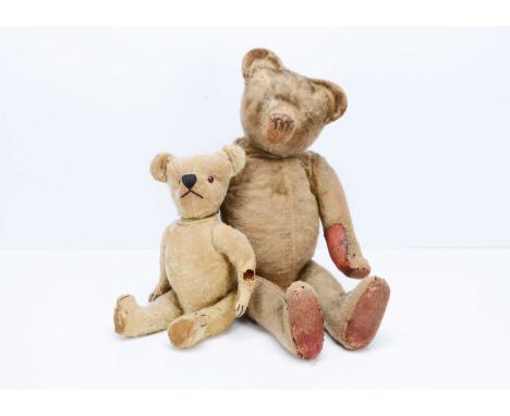 A large British 1920s teddy bear, with blonde mohair, pronounced muzzle with large stitched black nostrils, swivel head, join