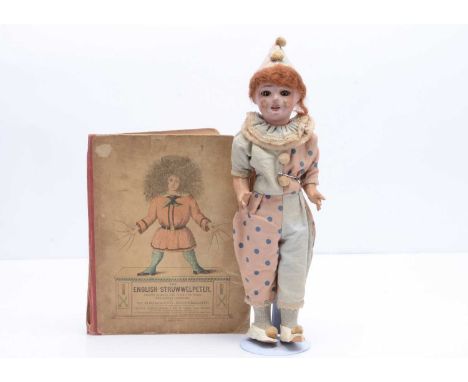 A French papier-mâché headed clown doll,  with light brown glass eyes, painted clown markings, auburn mohair wig, jointed str