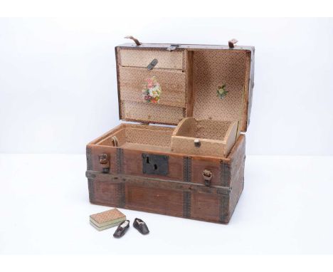 A 19th century doll’s trunk,  with domed lid, cover in printed paper, wooden banding, metal catch, opening to reveal printed 