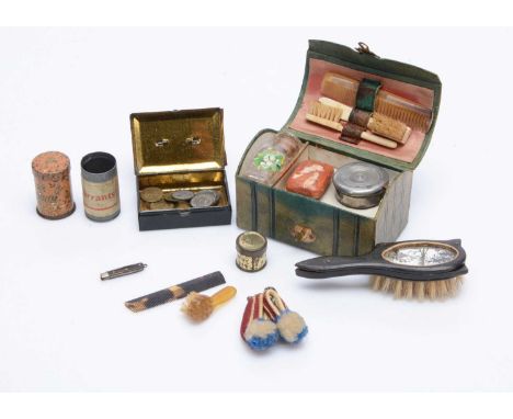 A 19th century small green leather doll’s trunk, with mother of pearl studs and gilt metal clasp, containing two bone tooth b