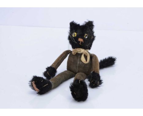 A 1920s Chad Valley Tango cat,  with black mohair, head, paws and tail, clear and black  cats eyes with yellow painted backs,