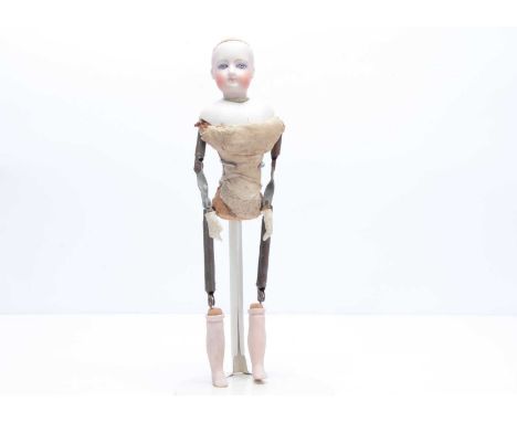 A Gaultier bisque swivel head fashion doll,  with pale blue eyes with darker rim to iris, light brown brow, pierces ears, bac