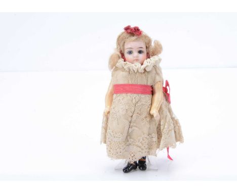 A Kammer & Reinhardt 192 dolls’ house doll, with blue glass eyes, closed mouth, blonde mohair wig, composition body jointed a