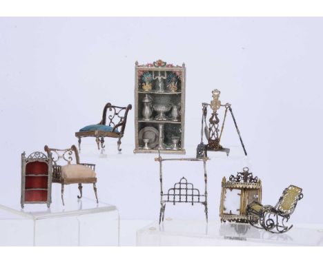 Late 19th century soft metal dolls’ house furniture,  comprising a pair of low chairs —2 ½in. (6cm.) high, a hanging corner s