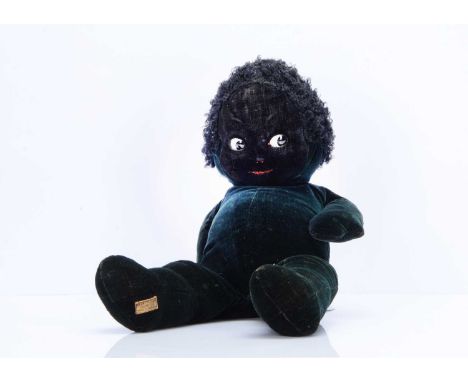 A Merrythought Dixie black doll, 1930s, of black velvet, inset large black and white googly side-glancing eyes, red painted o