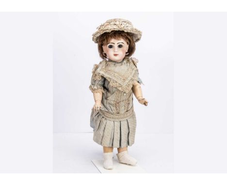 A Tete Jumeau bebe No.9, with fixed blue glass eyes, dark brown brows, closed mouth with slightly unpainted gap between, pier