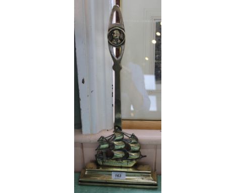 A Victorian brass 'Nelson' doorstop in the form of HMS Victory, the pierced handle with portrait bust titled 'Admiral Nelson'