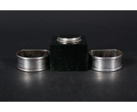 A pair of silver napkin rings with engine turned decoration together with onyx and silver plated inkwell