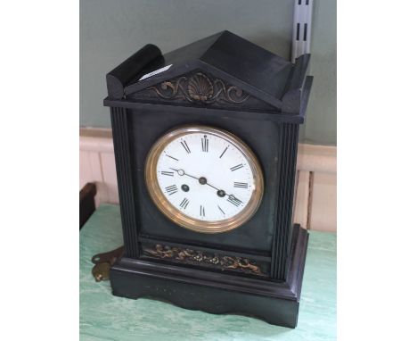 A black marble striking mantel clock