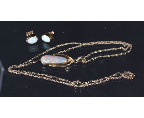 A 14ct gold and opal pendant on a yellow metal chain together with a pair of 9ct gold opal stud earrings