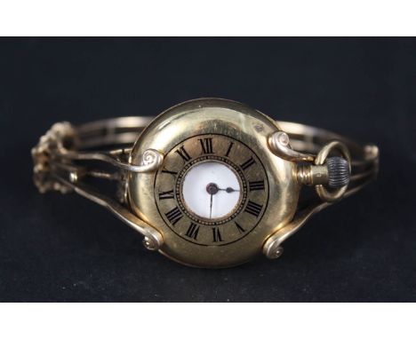 A lady's continental 18ct gold half hunter fob watch with unusual 15ct gold bangle to convert to wristwatch
