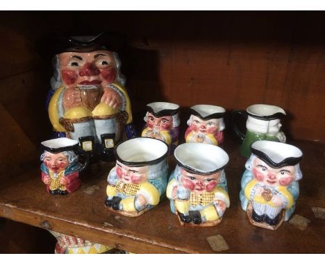 Eight Clarice Cliff Toby jugs