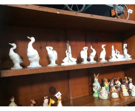 Nine Lladro and Nao swans