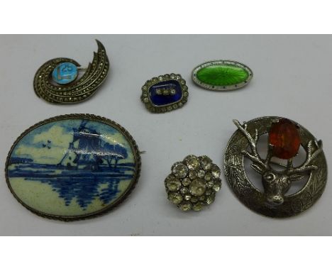 Six brooches including a Scottish silver stag brooch, enamel, etc., two a/f