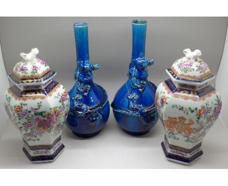 Two pairs of oriental vases;- one lapis blue with dragon decoration and a lidded pair with enamel decoration, one of each pai