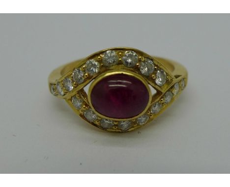 A yellow metal set ring with cabochon ruby and eighteen diamonds, 4.3g, O