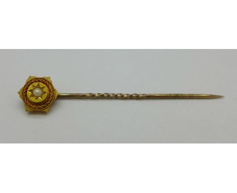 A 15ct gold stick pin set with a seed pearl