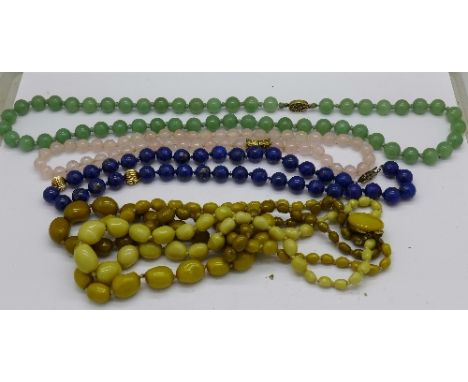 A string of jade beads with silver clasp and other bead necklaces, two with silver clasps