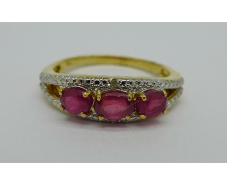 A silver gilt, ruby and diamond ring, V