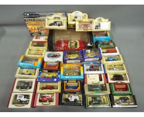 Burago Lledo, Matchbox, Oxford Diecasts - In excess of 30 boxed diecast model vehicles in various scales. lot includes Burago