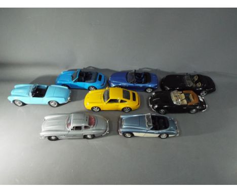 Eight unboxed 1:18 scale diecast model motor vehicles by Bburago / Burago, Maisto and ERTL.