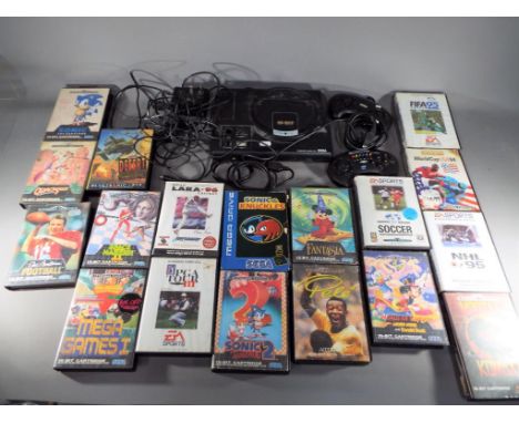 Sega - An unboxed Sega Mega Drive games console with two controllers and eighteen games cartridges including Sonic the Hedgeh