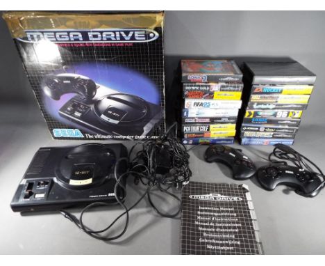 Sega - A boxed Sega Mega Drive games console with two controllers, instructions and eighteen game cartridges to include Sonic