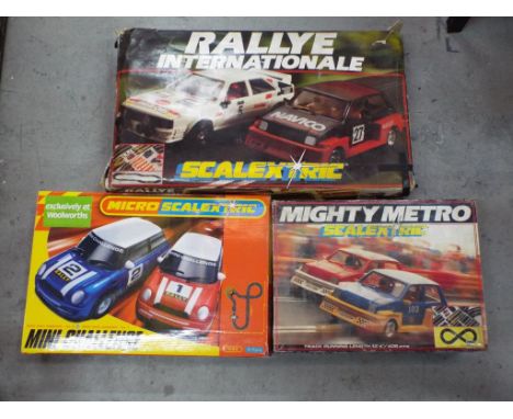 Scalextric - Three boxed Scalextric sets. Lot includes Rallye International; Mini Challenge; Mighty Mini Metro. All items are