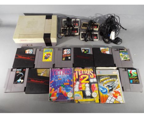 Nintendo - A Nintendo NES games console with four controllers and twelve games cartridges including Hook, Marble Madness, Tet