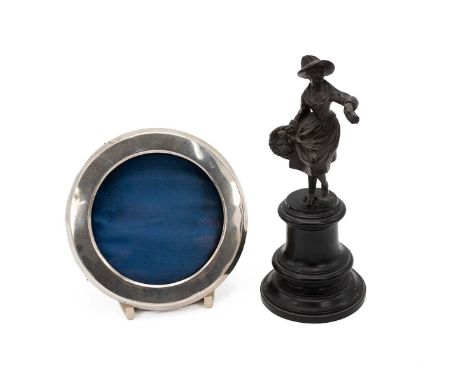 Small bronze statue of a flower seller, on ebonised base, unsigned, c1900. Also a silver circular photo frame, hallmarked Bir