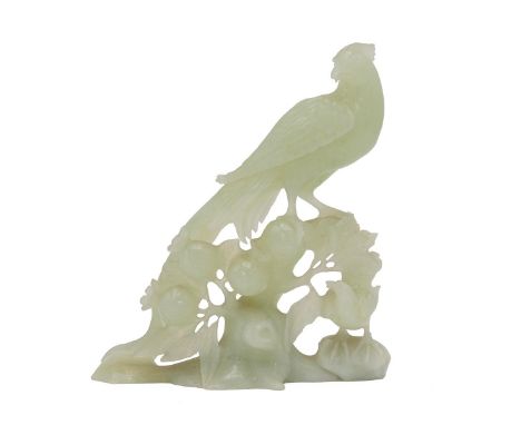 An oriental carved Jade figure of a golden pheasant on berries. H 15cm.