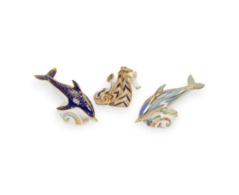 Three Royal Crown Derby paperweights, comprising Stripped Dolphin with gold stopper and box, Dolphin with gold stopper and Se