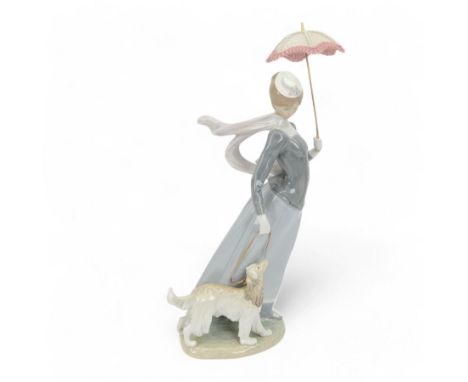 Lladro figure, Lady with Shawl, modeled as a woman holding a parasol with an afghan hound, model no 4914, H46cm 