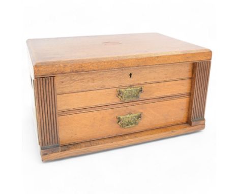 Early 20th century empty oak canteen box, of rectangular form, with lifting lid above two long drawers and with brass handles