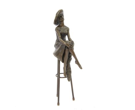 Bronze modelled as a female figure seated cross legged upon a chair, H28cm