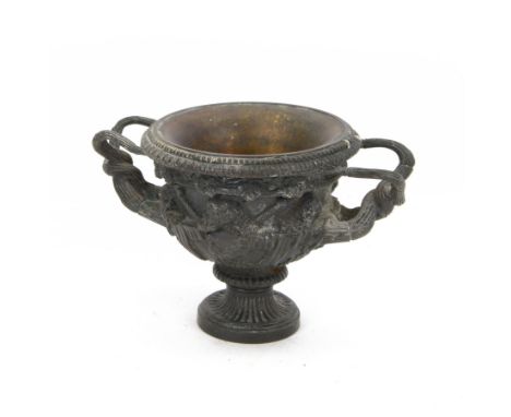 Patinated cast metal model of the 'Warwick Vase', after the antique, of typical form, cast in relief with Bacchic masks and T