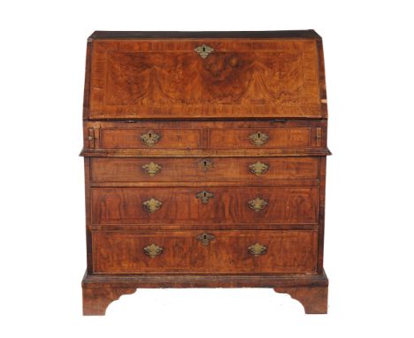 A George II walnut feather-banded bureau, circa 1750  A George II walnut feather-banded bureau,   circa 1750, the book-matche