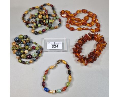 An amber bracelet and necklace, together with a collection of Scottish Picasso glass beaded necklaces and bracelet. (B.P. 21%