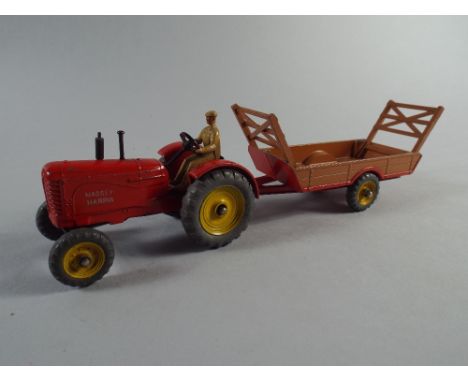 A Dinky Massey Harris Tractor and Halesowen Farm Trailer.