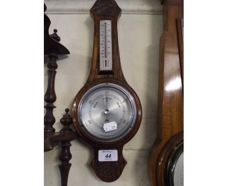 An Oak Wheel Barometer with Temperature Scale.