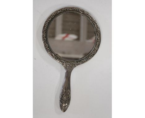A vintage white metal hand held mirror 
