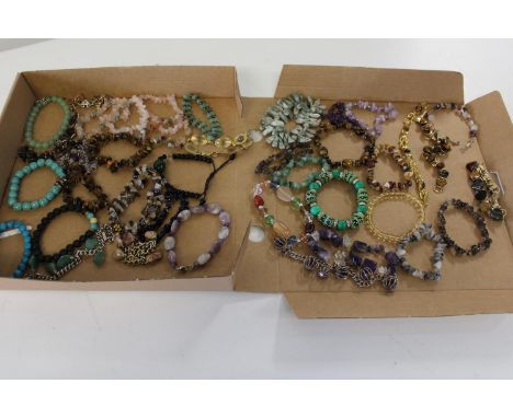A large selection of semi-precious stone necklaces including jade, amethyst &amp; tigers eye 