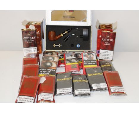 A large job lot of pipe tobacco with an electronic pipe 