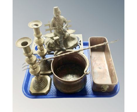 A tray containing antique metal ware to include Victorian brass candlesticks, toasting fork, trivet, brass figure of a man on