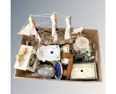 A box containing model galleon, antique mantle clock, old paraffin lamp, photograph frames etc.