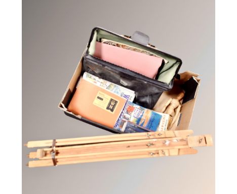 A vintage leather case containing art books together with a folding artist easel and a wooden mannequin, cased drawing instru