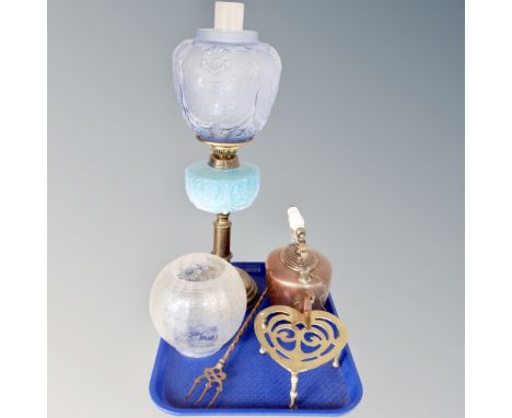 A 19th century oil lamp with blue glass reservoir and shade, porcelain-handled copper kettle, brass trivet and toasting fork 